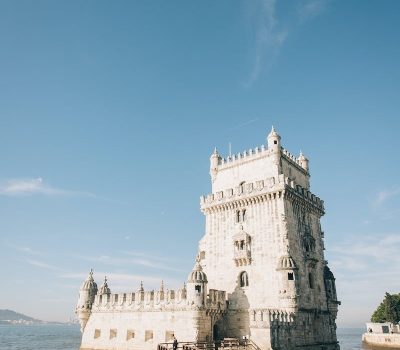 White Concrete Building Near Body of Water